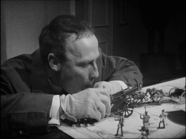 Callan firing a model canon at soldiers