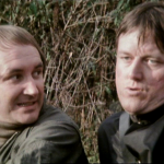 Concerned Vila looking at nastily lustful Doran