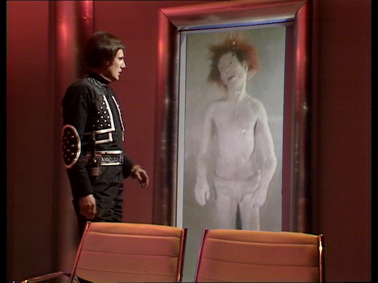 Avon looking at floating body of Colonel Astrid