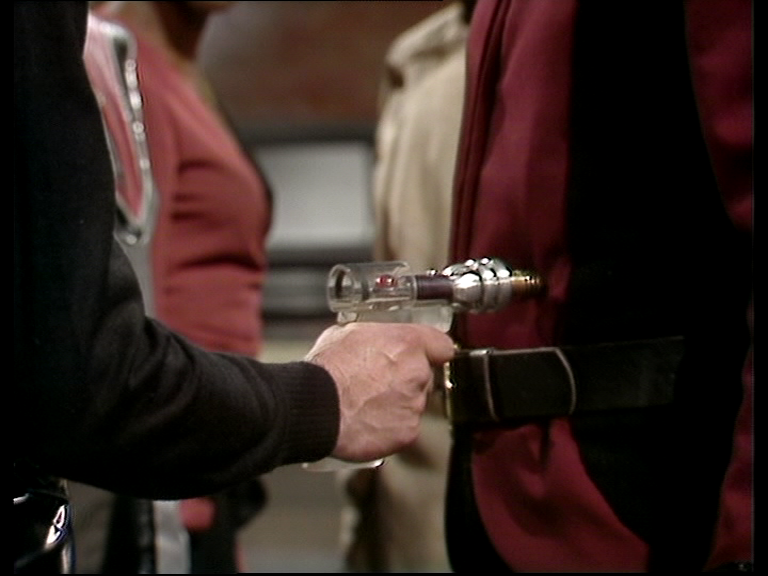 Avon pointing a transparent gun at Tarrant