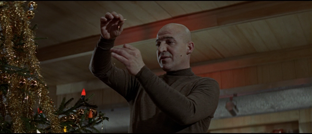 Blofeld picking up Christmas decoration