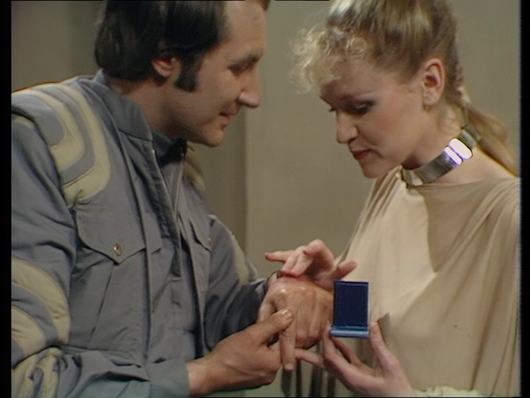 Pella soothing Vila's hand with an ointment in a small blue box