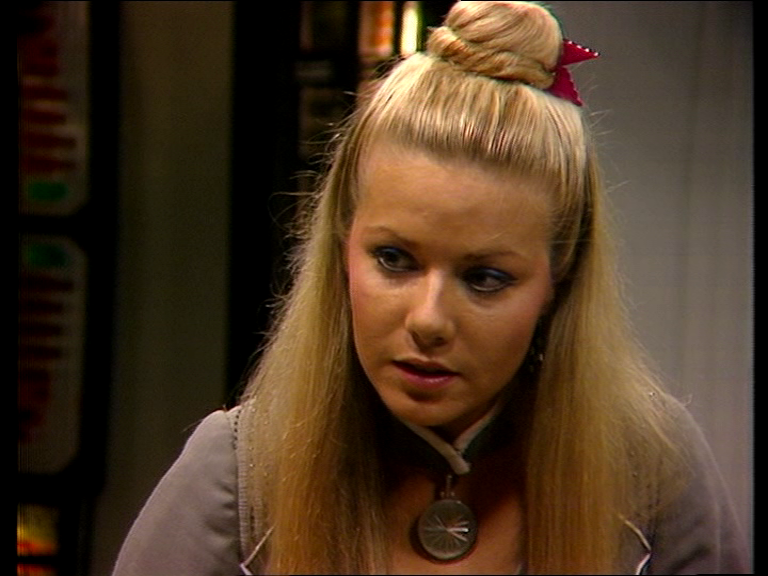 A young blonde lady with long hair half tied in a bun