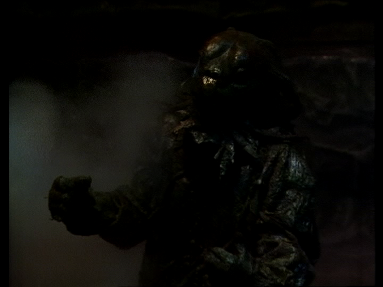 Large green humanoid monster in semi darkness