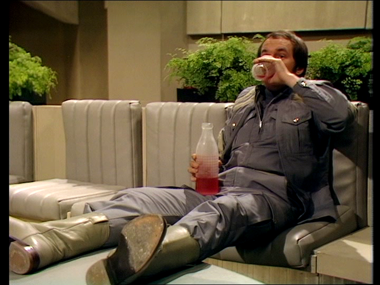 Vila sat on a sofa glugging wine