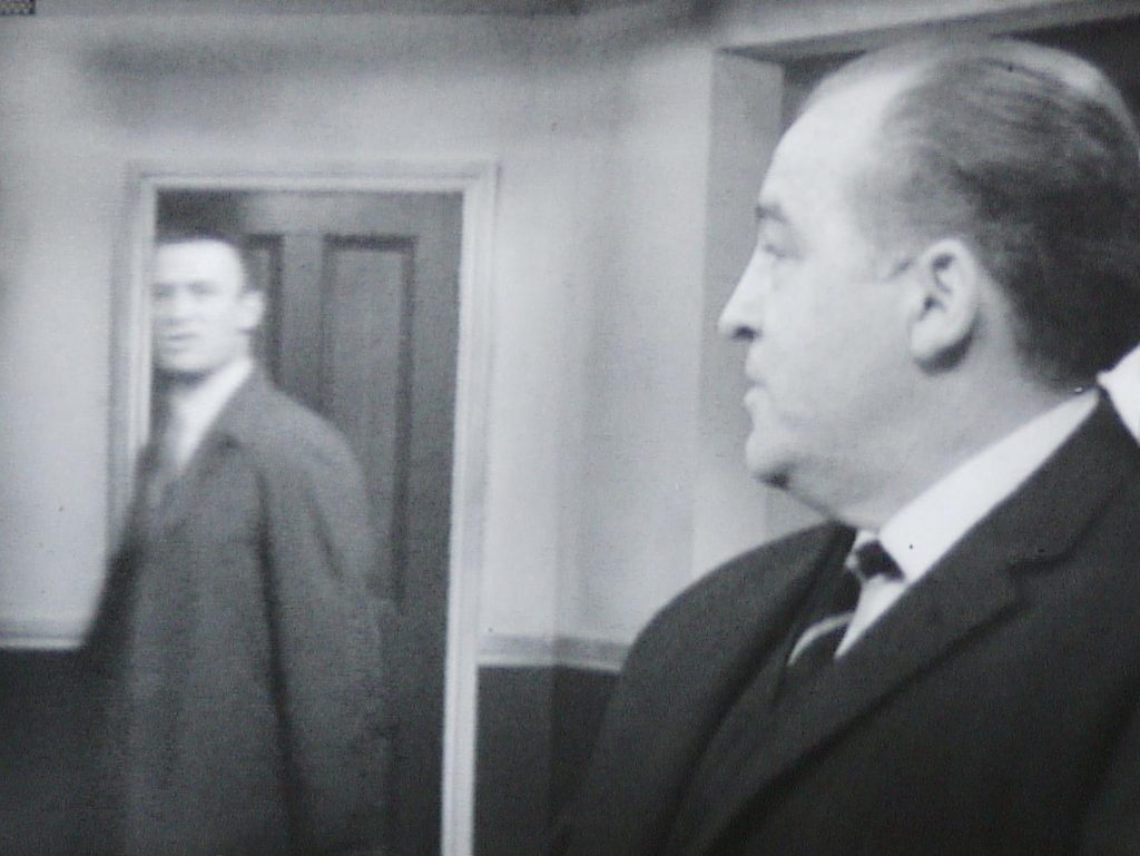 Callan heading to a door as Hunter looks over