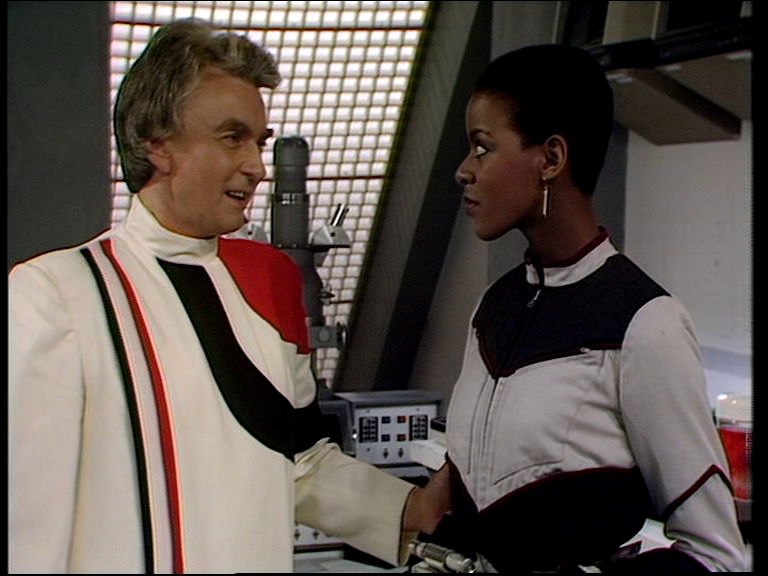 justin takes dayna's arm in a laboratory