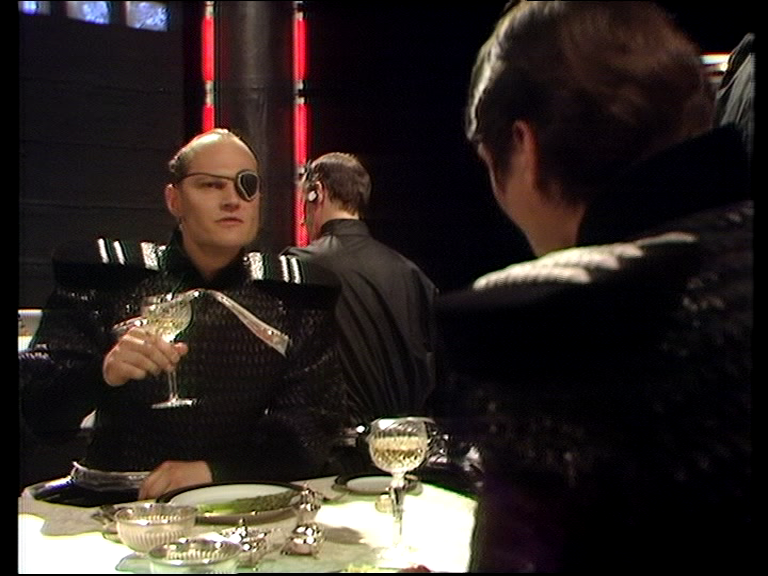 Eye patch Federation officer drinks wine over dinner