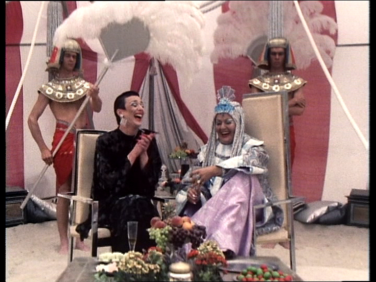 Servalan and Piri laughing on the beach with slaves fanning them