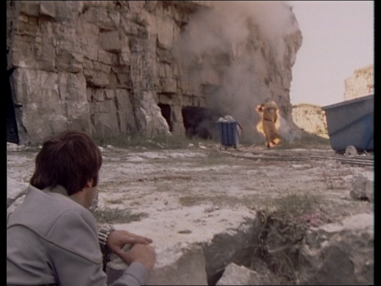 Vila watches a man running while on fire