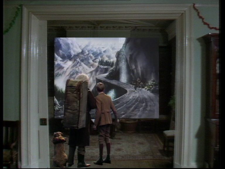 cole has made the picture on the wall larger and is about to step into it