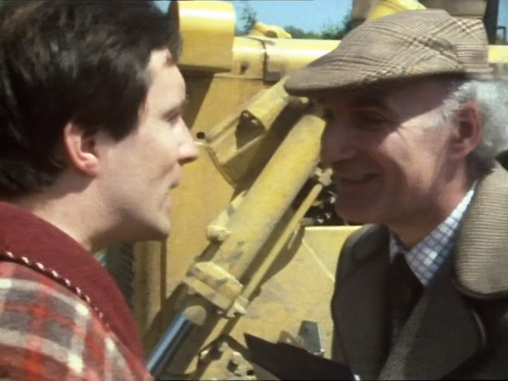 Arthur confronts the demolition man in font of a bulldozer