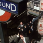 people emerging from tube station