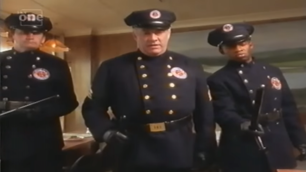 three police officers in old fashioned american uniforms