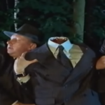 flynn and niven holding up a headless body