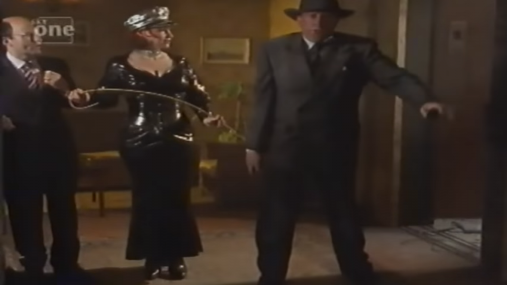 Flynn walking bow legged through the hotel reception