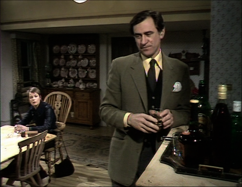 Arthur helps himself to another drink while abbey sits at the kitchen table