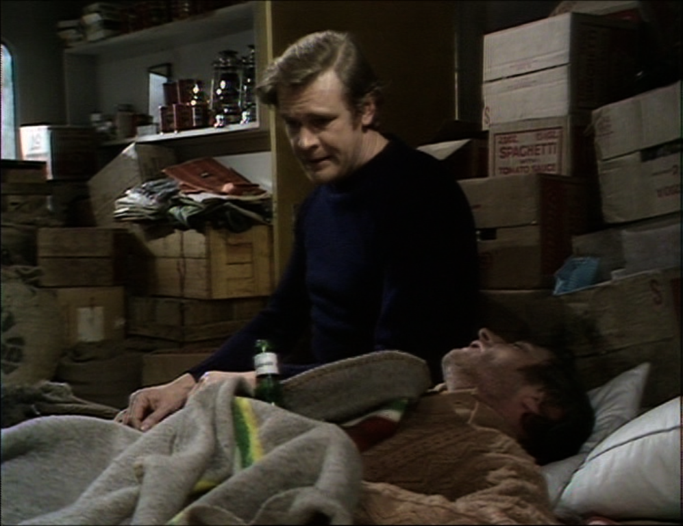 greg looks down at vic in bed