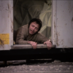 vic crawls out of the hut