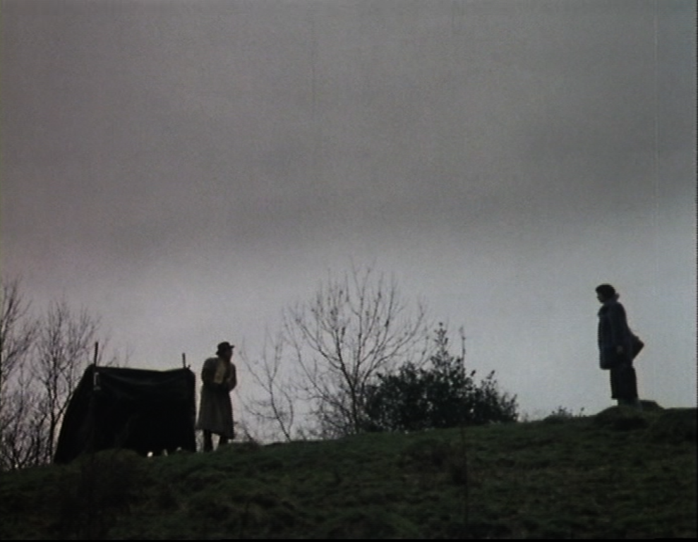 Tom and Jenny stand on a hill several metres away from one another