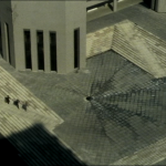 aerial view of concrete courtyard and brutalist building with vertical slits