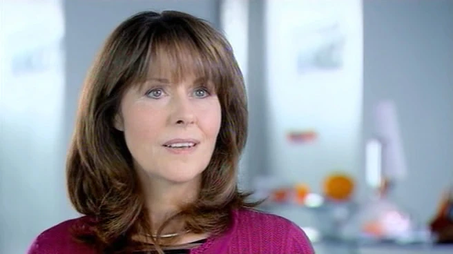 Sarah Jane looks off camera in an office