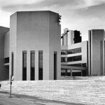 brutalist buildings, main one is hexagonal with narrow vertical slits in the bottom half
