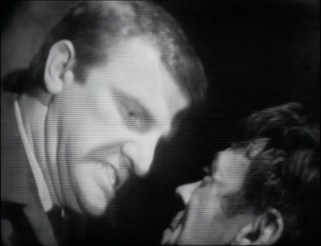 A grimacing Derek Newark grips Lonely by the collar.