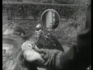 Wing mirror reflecting Hunter behind Bunin